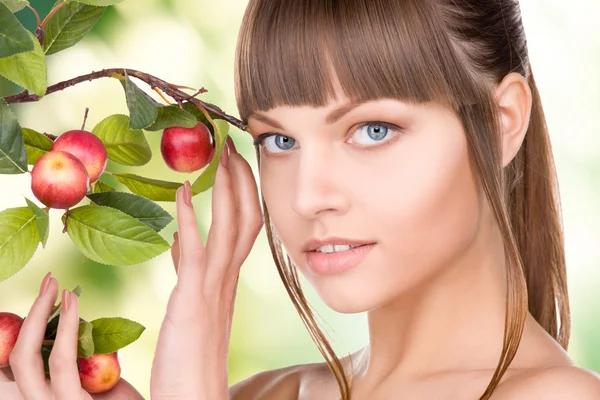 Lovely woman with apple twig Stock Picture