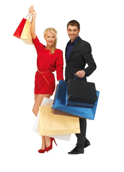 Homem e mulher com sacos de compras — Fotografia de Stock