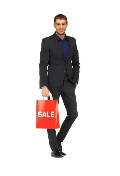 Handsome man in suit with shopping bags — Stock Photo, Image