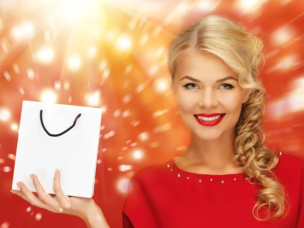 Lovely woman in red dress with shopping bag — Stock Photo, Image