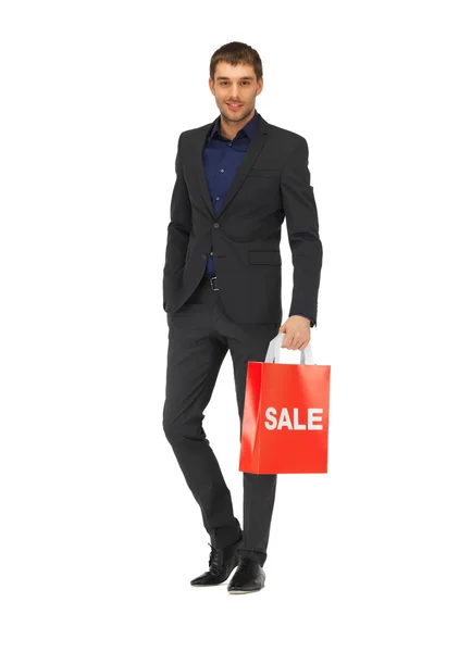 Bello uomo in giacca e cravatta con shopping bags — Foto Stock