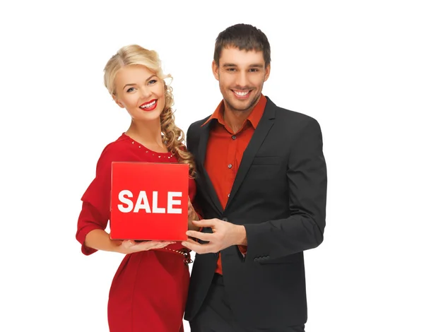 Muž a žena s nápis-na prodej — Stock fotografie