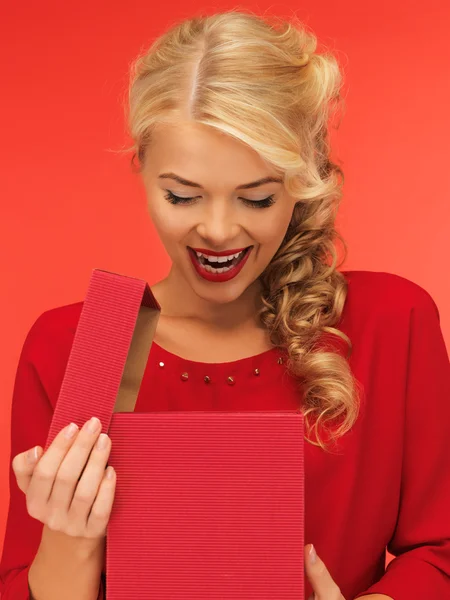 Lovely woman in red dress with opened gift box — 图库照片