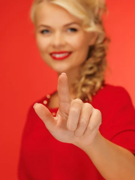 Woman in red dress pressing virtual button — Stock Photo, Image