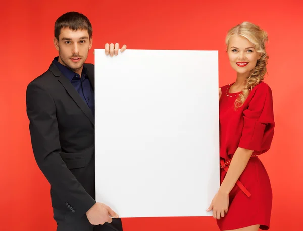 Couple holding big blank board — Stock Photo, Image