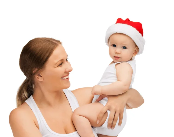 Mãe com bebê em santa chapéu ajudante — Fotografia de Stock