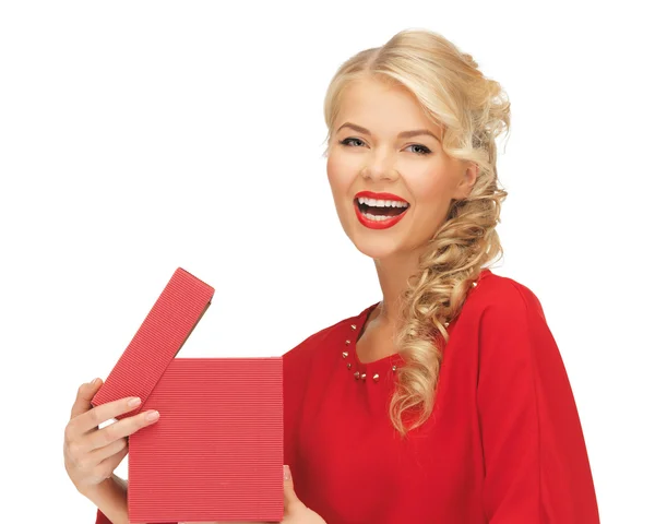 Lovely woman in red dress with opened gift box — Stock fotografie