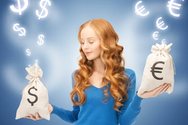 Woman with euro and dollar bags — Stock Photo, Image