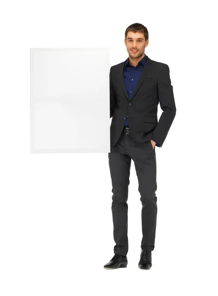 Bonito homem de terno com uma placa em branco — Fotografia de Stock