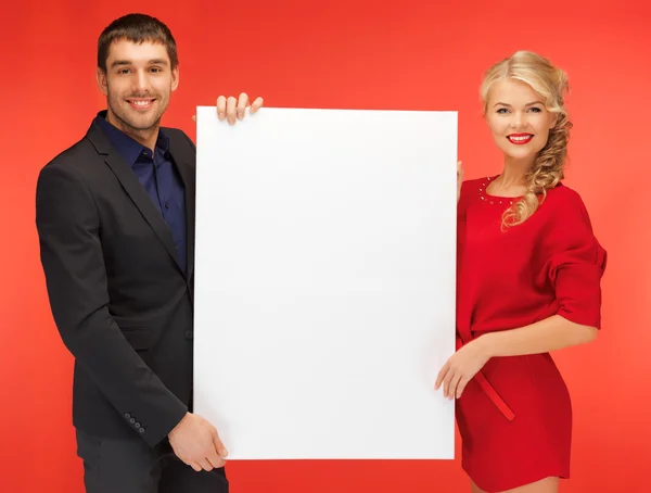 Couple holding big blank board — Stock Photo, Image