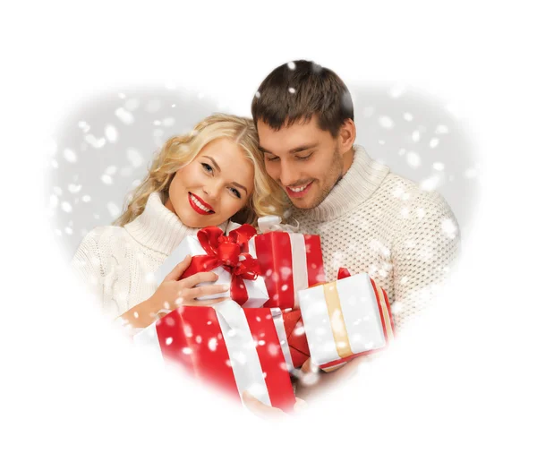 Romantic couple in a sweaters with gift boxes — Stock Photo, Image