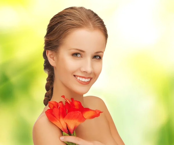 Beautiful woman with red lily flower — Stock Photo, Image