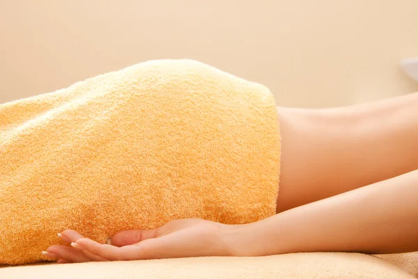 Woman lying on massage table — Stock Photo, Image