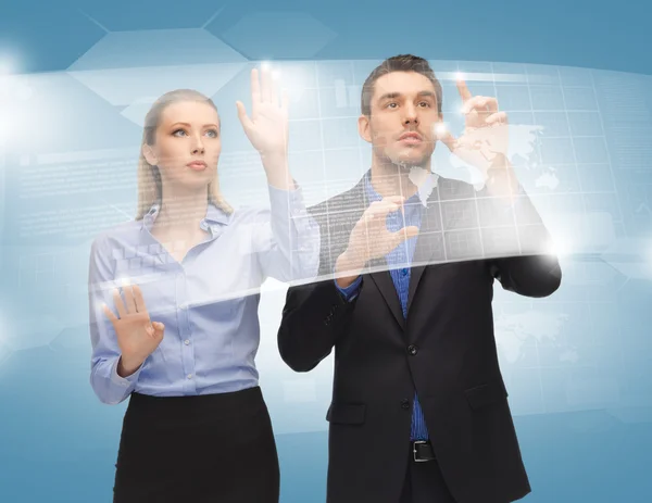 Man and woman working with virtual touch screens — Stock Photo, Image