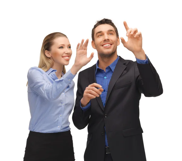 Hombre y mujer trabajando con algo imaginario — Foto de Stock