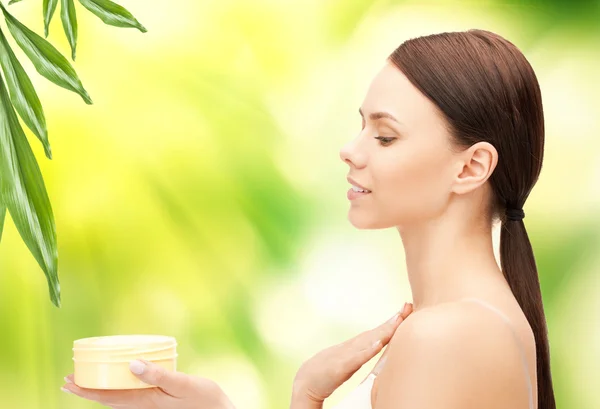 Beautiful woman with moisturizing creme — Stock Photo, Image