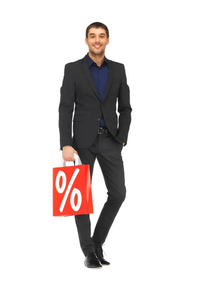 Hombre guapo en traje con bolsas de compras —  Fotos de Stock