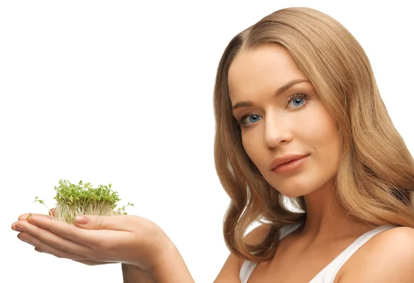 Vrouw met groen gras op palmen — Stockfoto