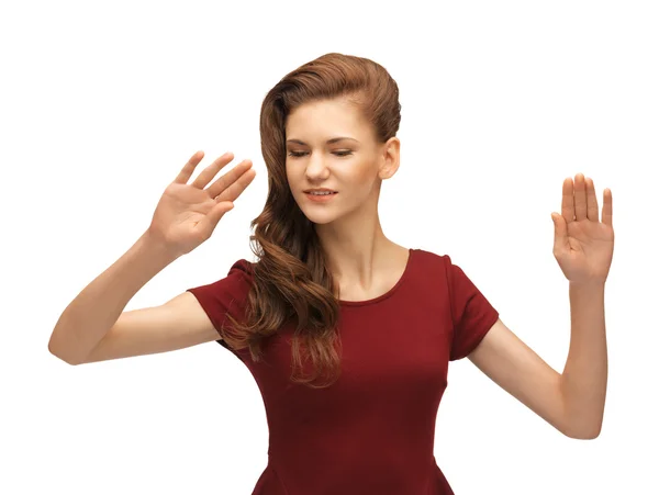 Girl in red dress working with something imaginary — Stock Photo, Image