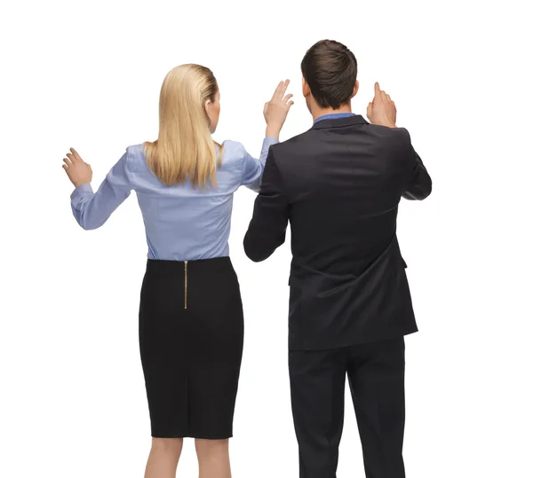 Man and woman working with something imaginary — Stock Photo, Image