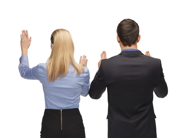 Man and woman working with something imaginary — Stock Photo, Image