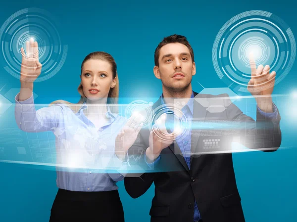 Man and woman working with virtual touch screens — Stock Photo, Image