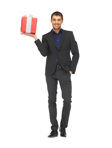 Hombre guapo en traje con una caja de regalo Fotos De Stock