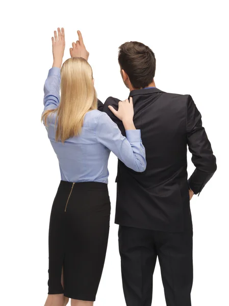 Man and woman working with something imaginary — Stock Photo, Image