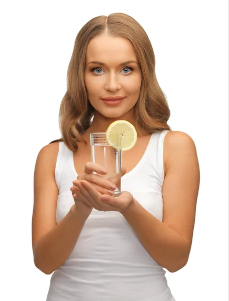 Woman with lemon slice on glass of water — Stock Photo, Image