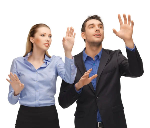 Man and woman working with something imaginary — Stock Photo, Image