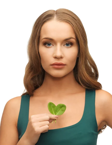 Woman with spinach leaves on palms — Stock Photo, Image