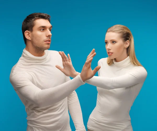 Man and woman working with something imaginary — Stock Photo, Image