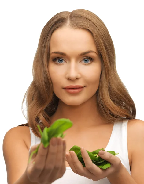 Woman with spinach leaves on palms — Stock Photo, Image