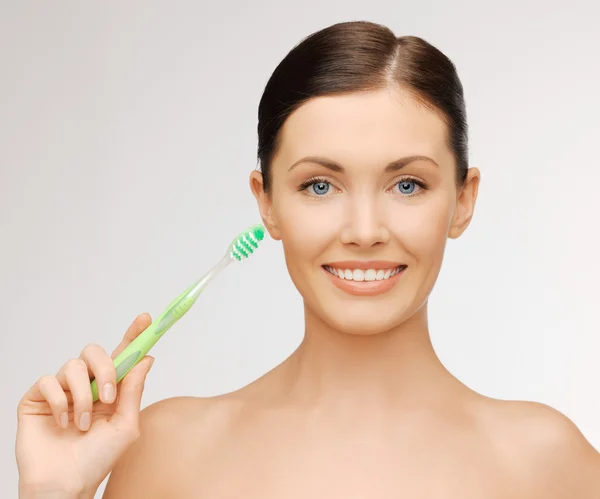 Mujer con cepillo de dientes —  Fotos de Stock