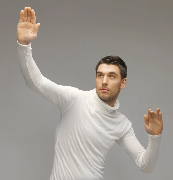 Man working with something imaginary — Stock Photo, Image