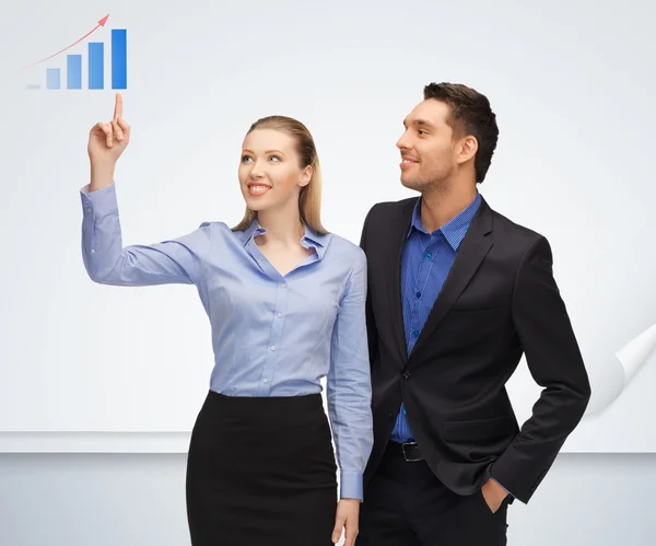 Man and woman pointing their fingers to chart — Stock Photo, Image