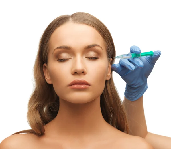 Woman face and beautician hands — Stock Photo, Image