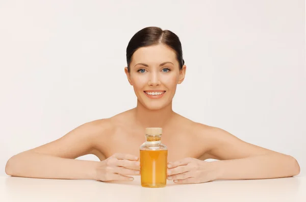 Woman with oil bottle — Stock Photo, Image