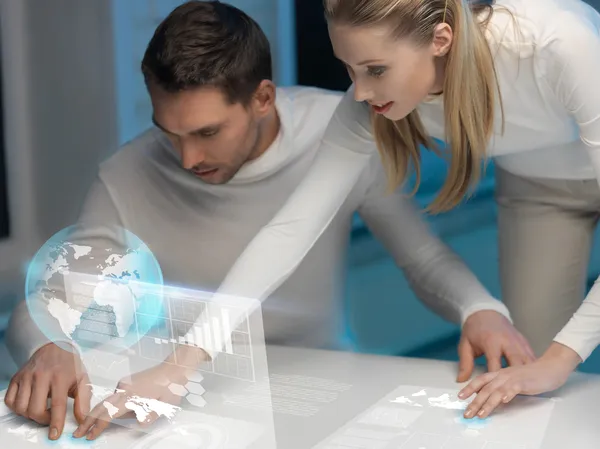 Man and woman working with virtual screens — Stock Photo, Image