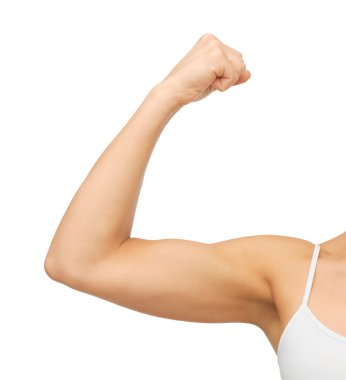 Sporty woman flexing her biceps clipart