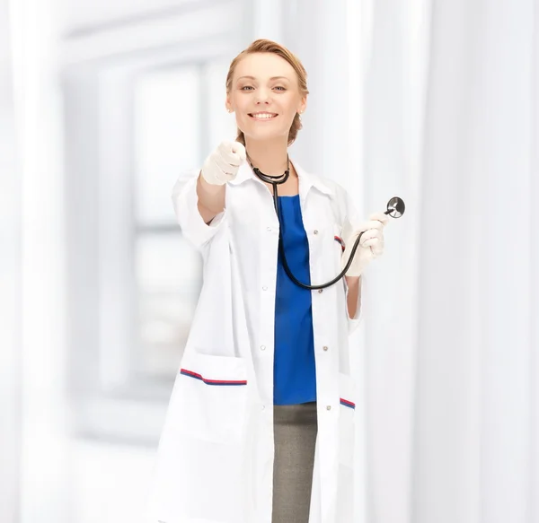 Atraktivní ženský lékař ukazující prst — Stock fotografie