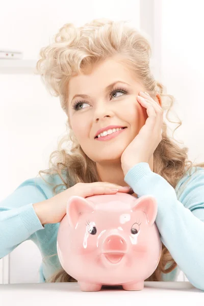 Lovely woman with piggy bank Royalty Free Stock Images