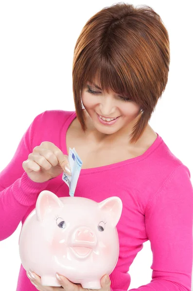 Schöne Frau mit Sparschwein und Geld — Stockfoto