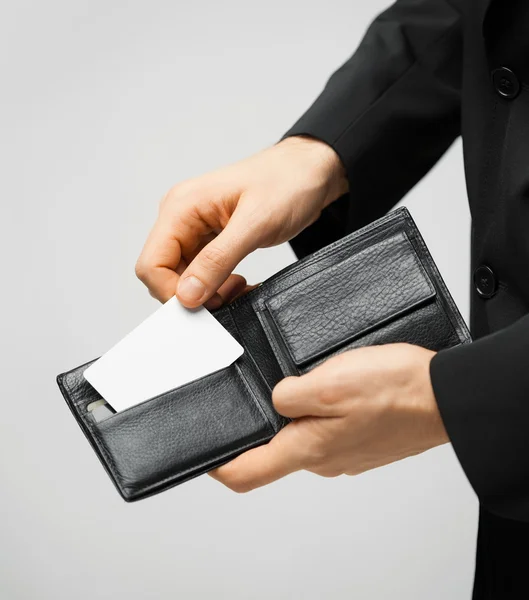 Man in suit holding credit card — Stock Photo, Image