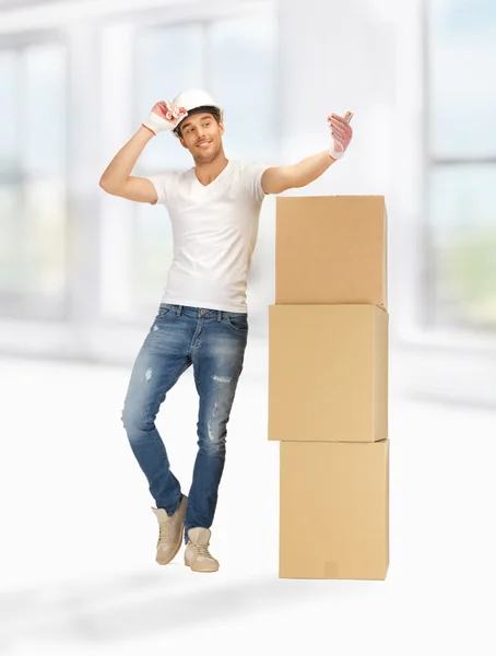 Handsome builder with big boxes — Stock Photo, Image