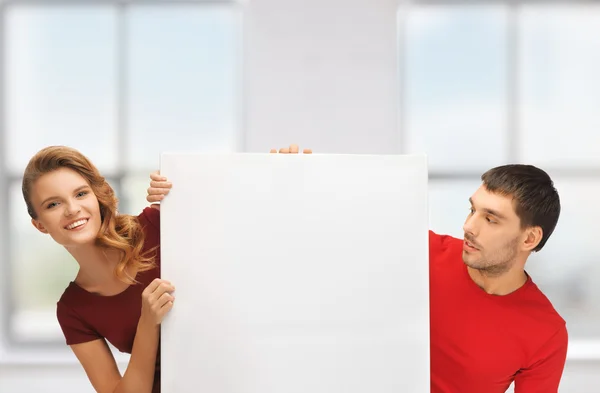 Man and woman with big blank board — Stock Photo, Image