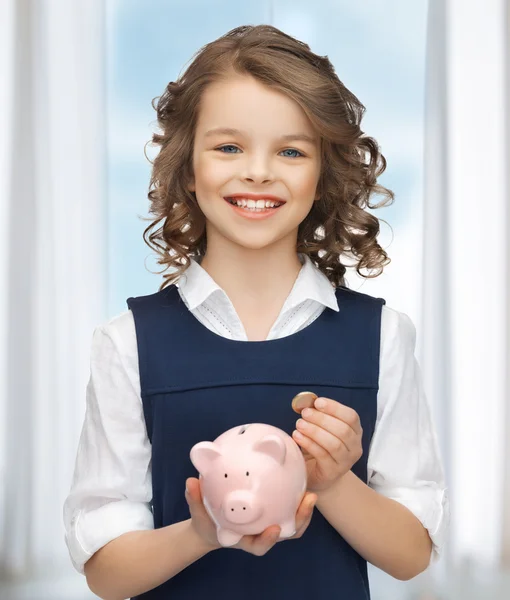 Menina com banco porquinho — Fotografia de Stock