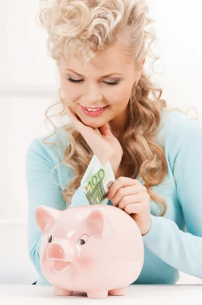 Woman with piggy bank and cash money Stock Photo