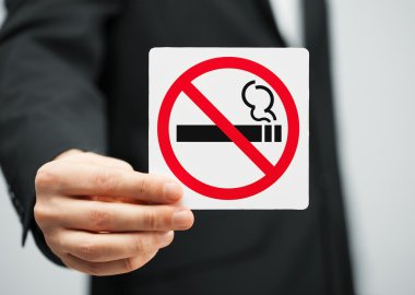 Man in suit holding no smoking sign clipart