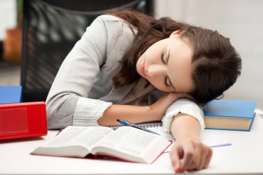Bored and tired woman sleeping on the table clipart